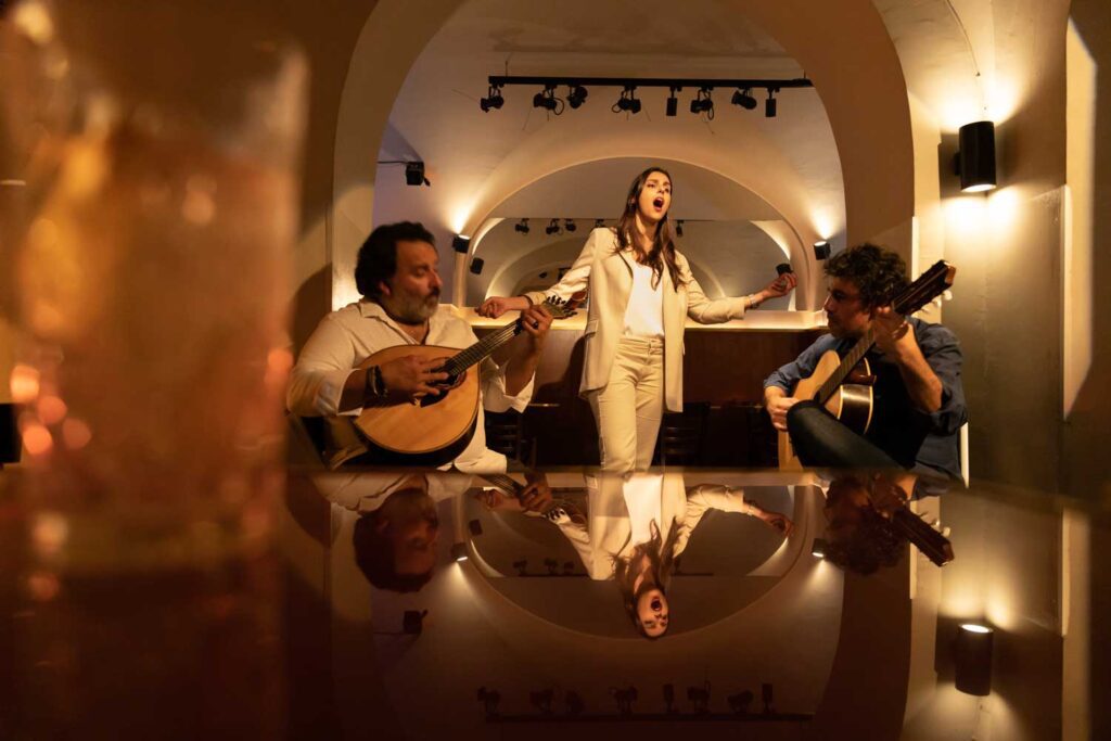 fado musicians in Lisbon, Portugal with cocktail in foreground