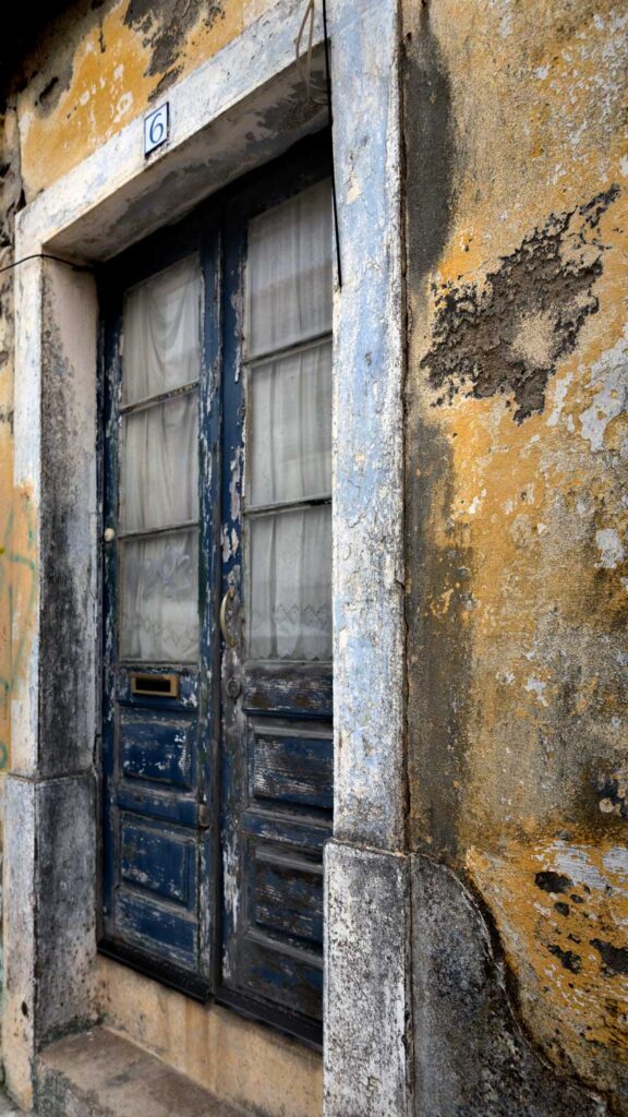 a photo of a distressed wooden door in Ericeria, Portugal