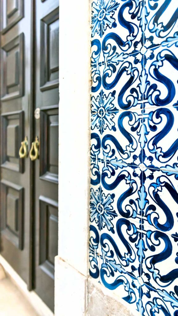 a photo of blue and white tile or azulejos and door in Portugal