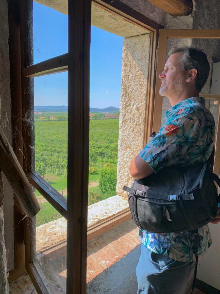 man looking out of window in wine cellar at Masi Agricola