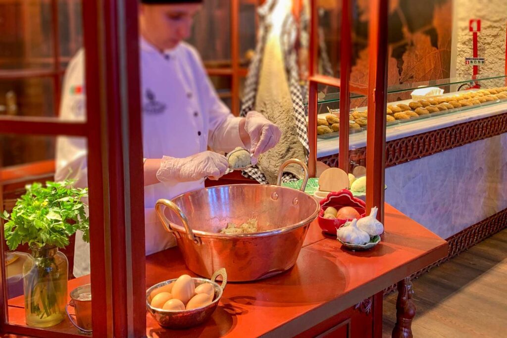 a woman is making bacalhau or salted cod in Porto, Portugal at Casa Portuguesa do Pastel de Bacalhau - Gaia